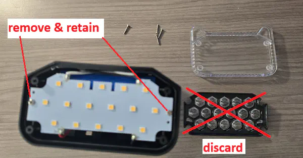 Annotated photo of the disassembled front panel, with the focus lens crossed out as “discard”